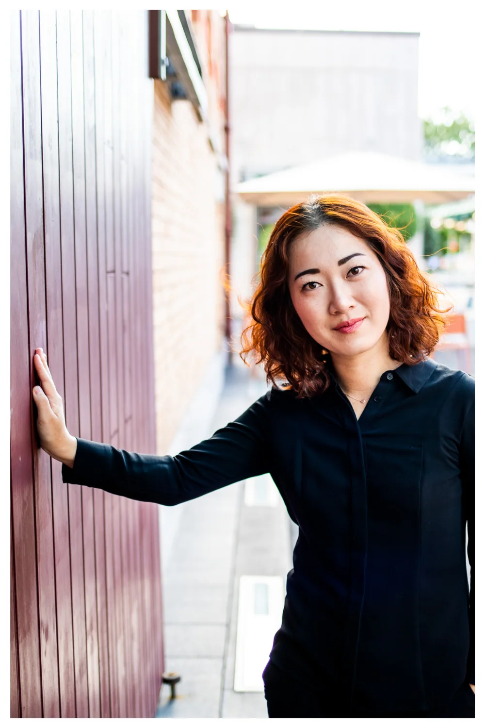 Wellness practitioner brand portrait on a city street by Lola Media